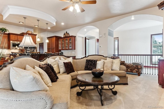 living room with light carpet and ceiling fan