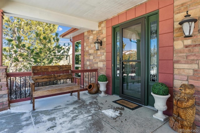 view of exterior entry featuring a porch