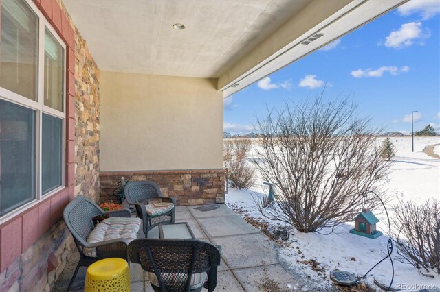 view of snow covered patio