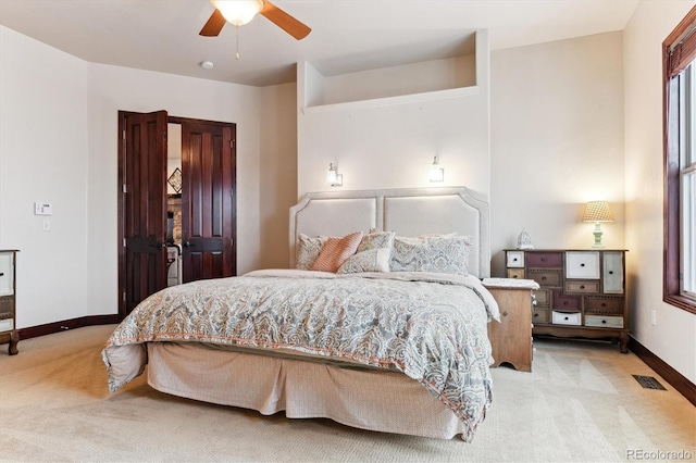 bedroom with light carpet and ceiling fan