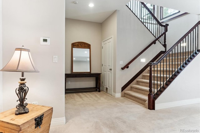 entryway featuring light colored carpet