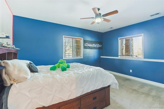 bedroom with ceiling fan and light carpet