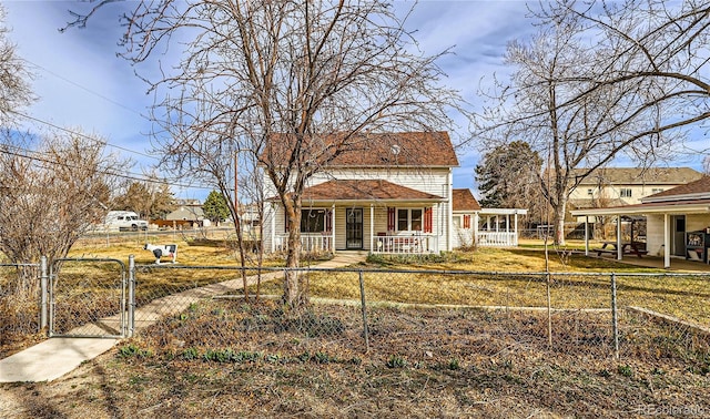 view of front of property with a fenced front yard, a porch, and a gate