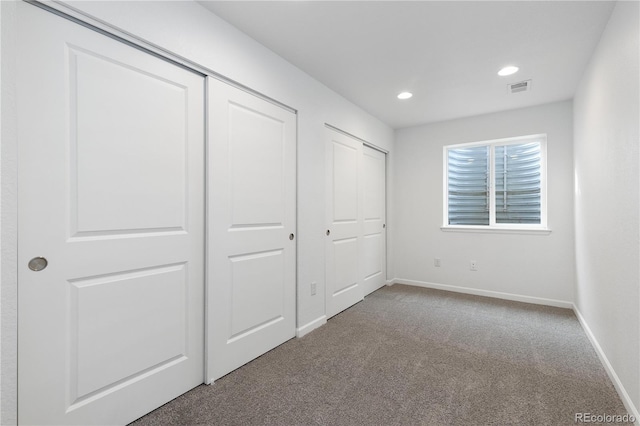 unfurnished bedroom with recessed lighting, baseboards, visible vents, and carpet flooring