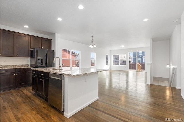 kitchen with dark wood-style flooring, a sink, open floor plan, stainless steel dishwasher, and black refrigerator with ice dispenser