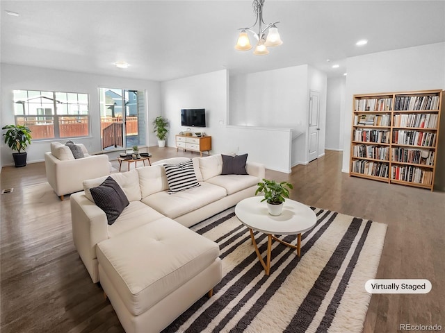 living area with visible vents, a chandelier, wood finished floors, and recessed lighting