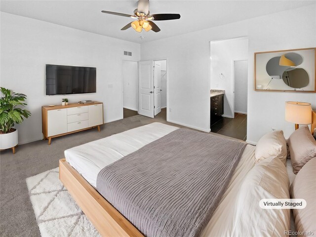 bedroom featuring a spacious closet, connected bathroom, visible vents, and a ceiling fan