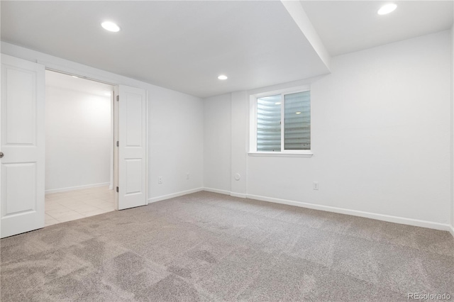 unfurnished room featuring tile patterned flooring, baseboards, carpet flooring, and recessed lighting