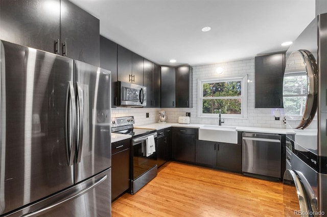 2309 Magellan St, Colorado Springs, CO 80907 - kitchen with appliances with stainless steel finishes, dark cabinetry, backsplash, and recessed lighting