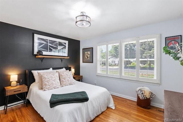 2309 Magellan St, Colorado Springs, CO 80907 - bedroom featuring wood finished floors and an accent wall