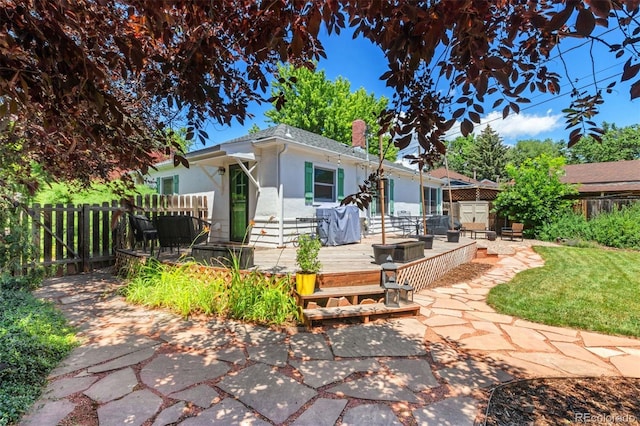 2309 Magellan St, Colorado Springs, CO 80907 - view of front of home with a deck, stucco siding, a fenced backyard, and a patio area