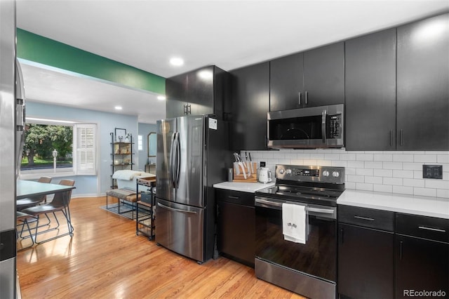 2309 Magellan St, Colorado Springs, CO 80907 - kitchen with stainless steel appliances, dark cabinets, light countertops, light wood-type flooring, and recessed lighting