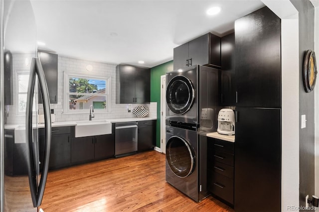 2309 Magellan St, Colorado Springs, CO 80907 - laundry room featuring estacked washer and dryer, light wood finished floors, and recessed lighting