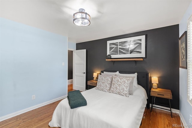 2309 Magellan St, Colorado Springs, CO 80907 - bedroom with wood finished floors and an accent wall
