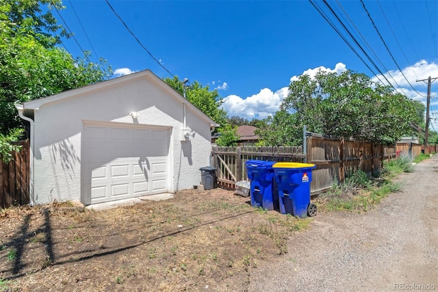 2309 Magellan St, Colorado Springs, CO 80907 - view of side of property featuring stucco siding, an outbuilding, and a detached garage