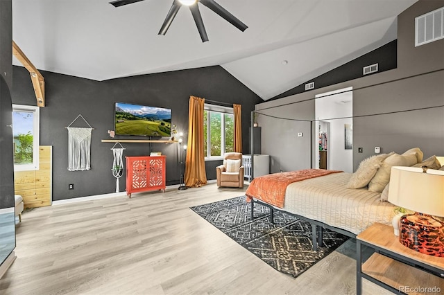 bedroom featuring wood finished floors, lofted ceiling, and a ceiling fan