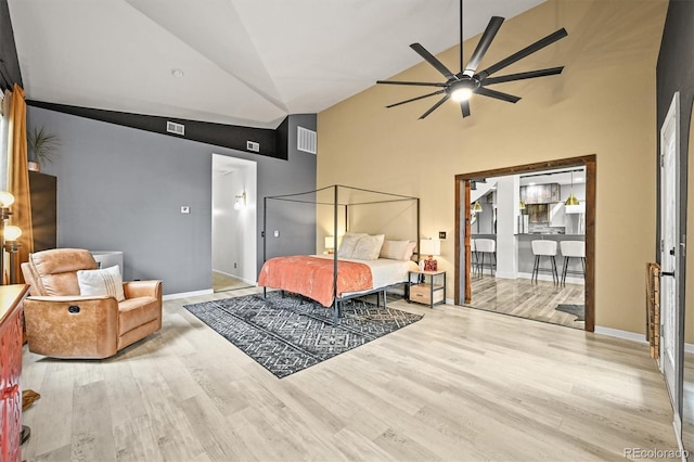 bedroom featuring high vaulted ceiling, wood finished floors, baseboards, and ceiling fan