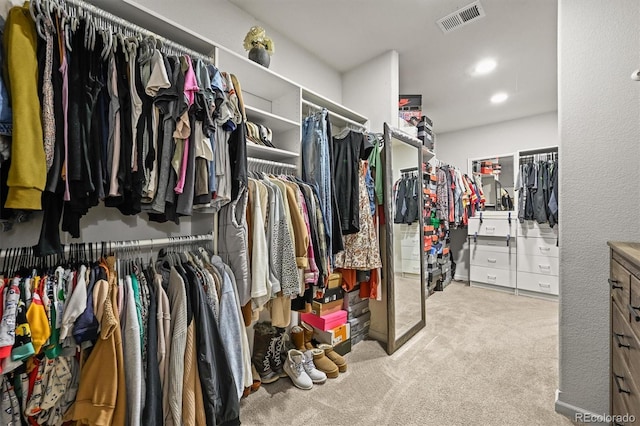 walk in closet with carpet