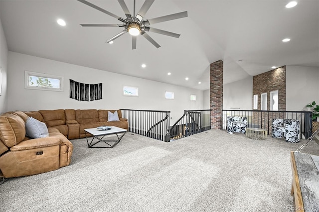carpeted living room with ceiling fan, recessed lighting, and lofted ceiling