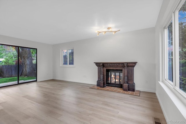 1304 Ceres Dr, Lafayette, CO 80026 - unfurnished living room with wood finished floors, baseboards, and a tiled fireplace