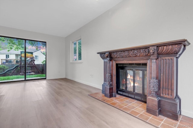 1304 Ceres Dr, Lafayette, CO 80026 - unfurnished living room with a glass covered fireplace, healthy amount of natural light, wood finished floors, and baseboards