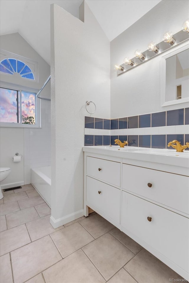 1304 Ceres Dr, Lafayette, CO 80026 - full bathroom featuring vanity, lofted ceiling, toilet, tile patterned floors, and shower / bath combination