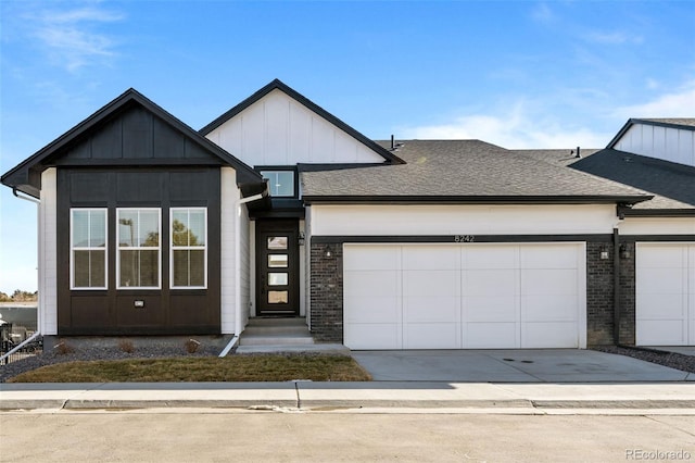 8242 S Pierson St, Littleton, CO 80127 - view of front of house with a garage, a shingled roof, and driveway