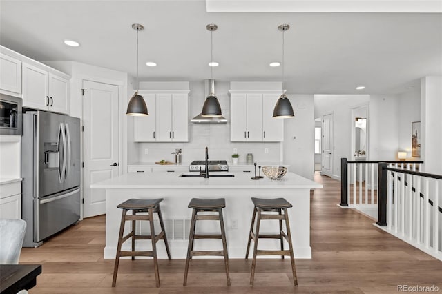 8242 S Pierson St, Littleton, CO 80127 - kitchen featuring light countertops, stainless steel appliances, and an island with sink