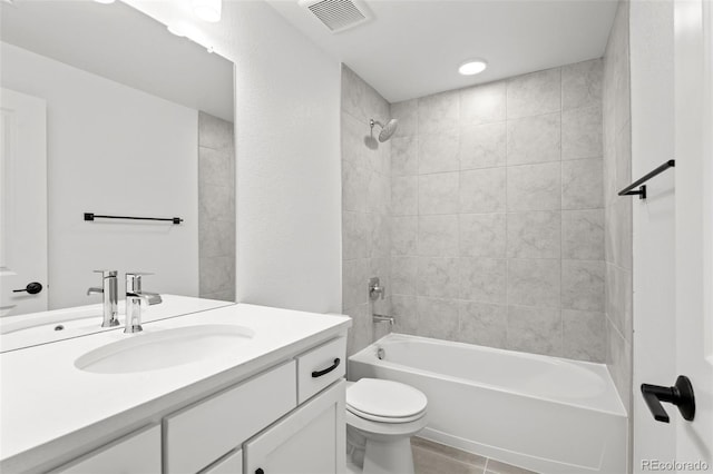 8242 S Pierson St, Littleton, CO 80127 - bathroom featuring toilet, vanity, visible vents, tile patterned flooring, and bathtub / shower combination