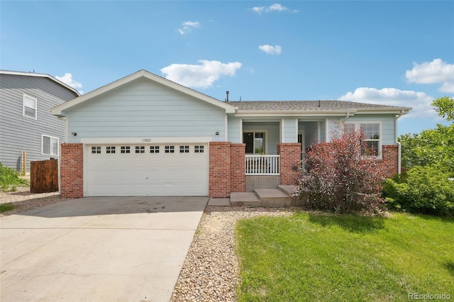 13802 Jasmine St, Thornton, CO 80602 - view of front facade featuring brick siding, driveway, a garage, a porch, and a front lawn