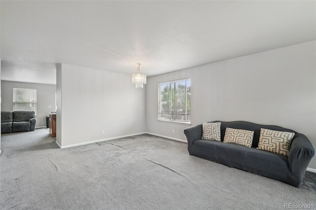 13802 Jasmine St, Thornton, CO 80602 - living room with a chandelier, carpet floors, and healthy amount of natural light