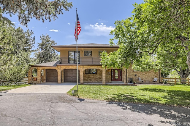 12196 W Belleview Dr, Littleton, CO 80127 - view of front of house featuring a balcony, driveway, and a garage