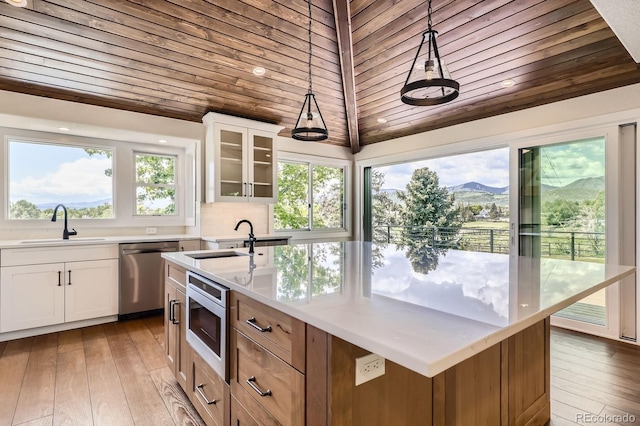 12196 W Belleview Dr, Littleton, CO 80127 - kitchen with appliances with stainless steel finishes, a sink, wooden ceiling, decorative light fixtures, and white cabinetry