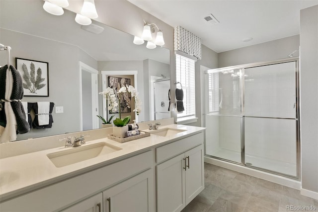 bathroom featuring vanity and a shower with door