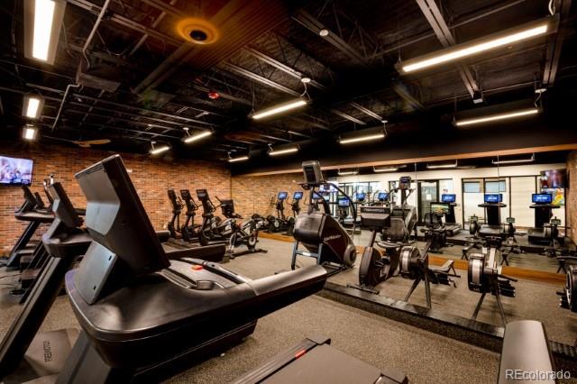 workout area featuring brick wall