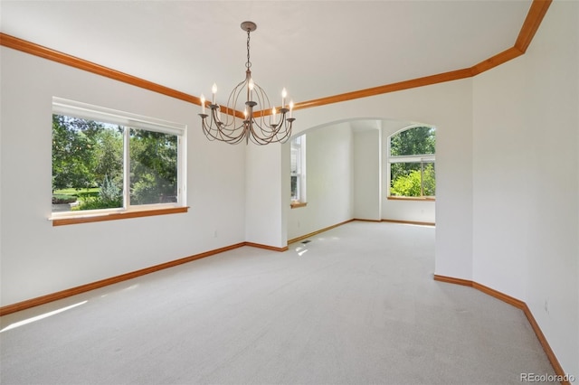 2247 Eagles Nest Dr, Lafayette, CO 80026 - empty room with arched walkways, a chandelier, carpet, and crown molding