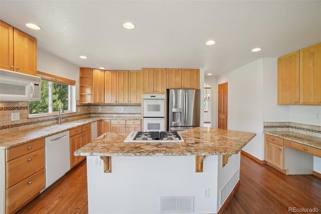 2247 Eagles Nest Dr, Lafayette, CO 80026 - kitchen featuring white appliances, open shelves, a kitchen island, a kitchen bar, and wood finished floors