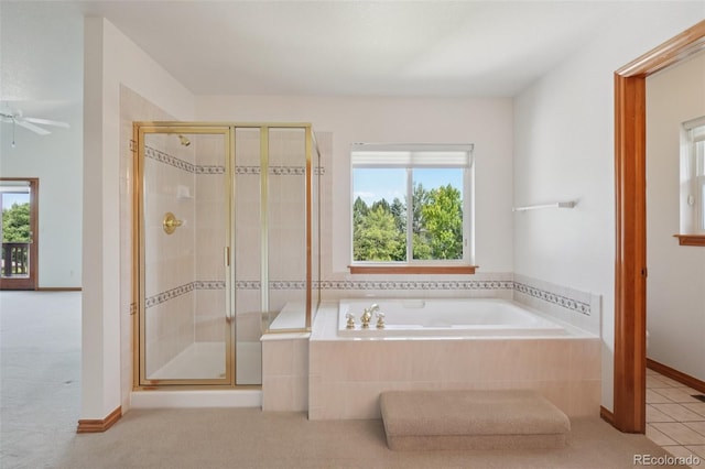 2247 Eagles Nest Dr, Lafayette, CO 80026 - full bath featuring a shower stall, a bath, tile patterned floors, and a ceiling fan