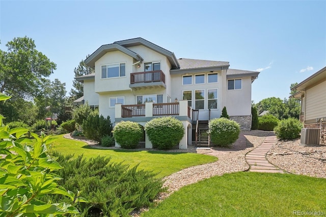 2247 Eagles Nest Dr, Lafayette, CO 80026 - back of property with a balcony, stucco siding, a lawn, and stairway