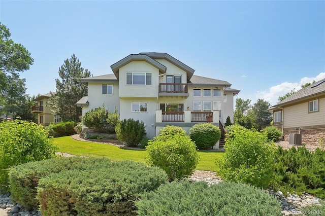 2247 Eagles Nest Dr, Lafayette, CO 80026 - rear view of property with a balcony, stucco siding, and a yard