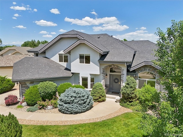 2247 Eagles Nest Dr, Lafayette, CO 80026 - view of front of house with stone siding, stucco siding, and a shingled roof