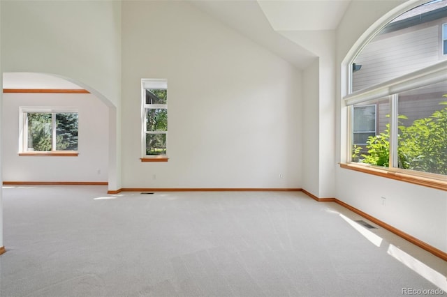 2247 Eagles Nest Dr, Lafayette, CO 80026 - carpeted empty room featuring arched walkways and a towering ceiling