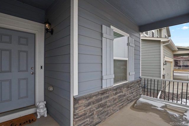 view of exterior entry featuring a porch