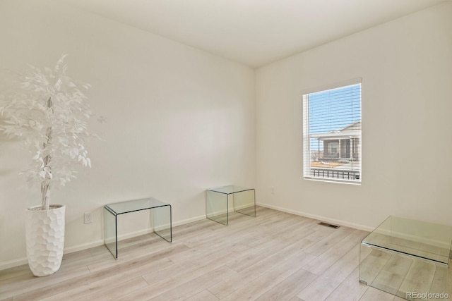 spare room featuring light wood-type flooring