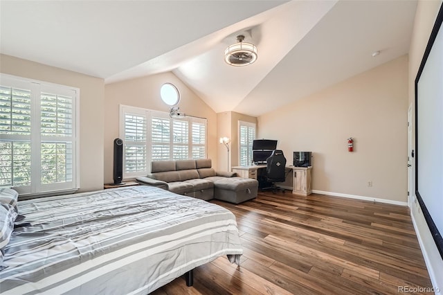 bedroom with lofted ceiling, dark wood-type flooring, and multiple windows