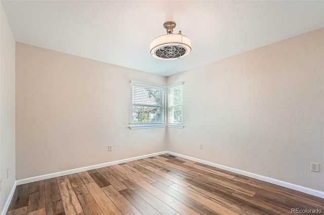 unfurnished room with hardwood / wood-style floors