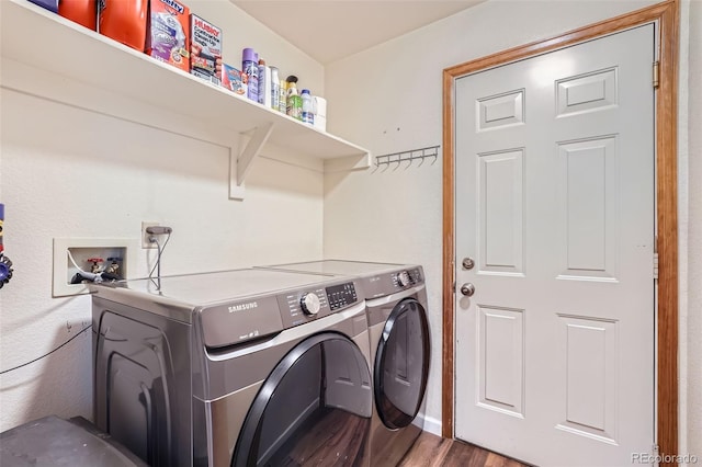 laundry area featuring hardwood / wood-style floors and washing machine and clothes dryer