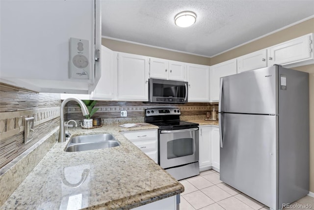3022 S Wheeling Way Unit 107, Aurora, CO 80014 - kitchen featuring appliances with stainless steel finishes, white cabinetry, tasteful backsplash, light stone countertops, and a textured ceiling
