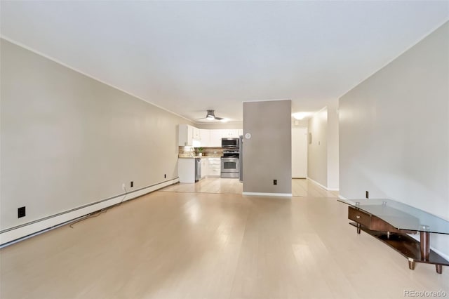 3022 S Wheeling Way Unit 107, Aurora, CO 80014 - unfurnished living room with a baseboard radiator and light wood-style floors