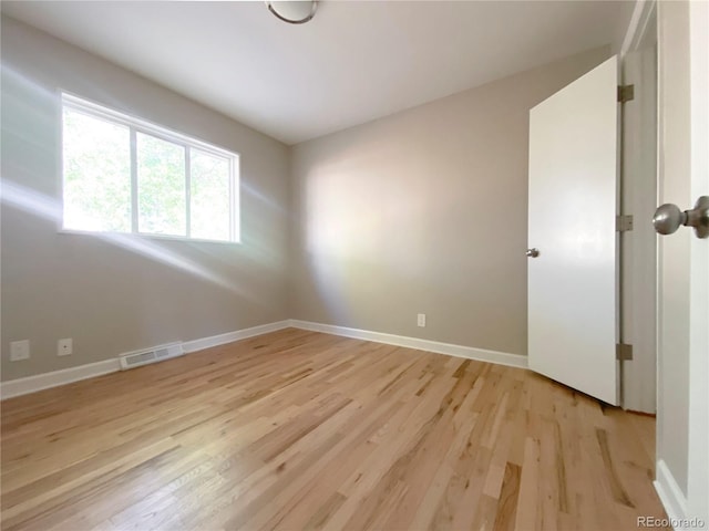 spare room with light hardwood / wood-style flooring